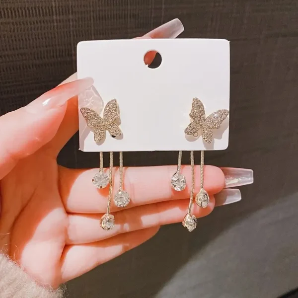 Elegant gold butterfly dangle earrings with sparkling zirconia accents, stylish jewelry for weddings and everyday glamour