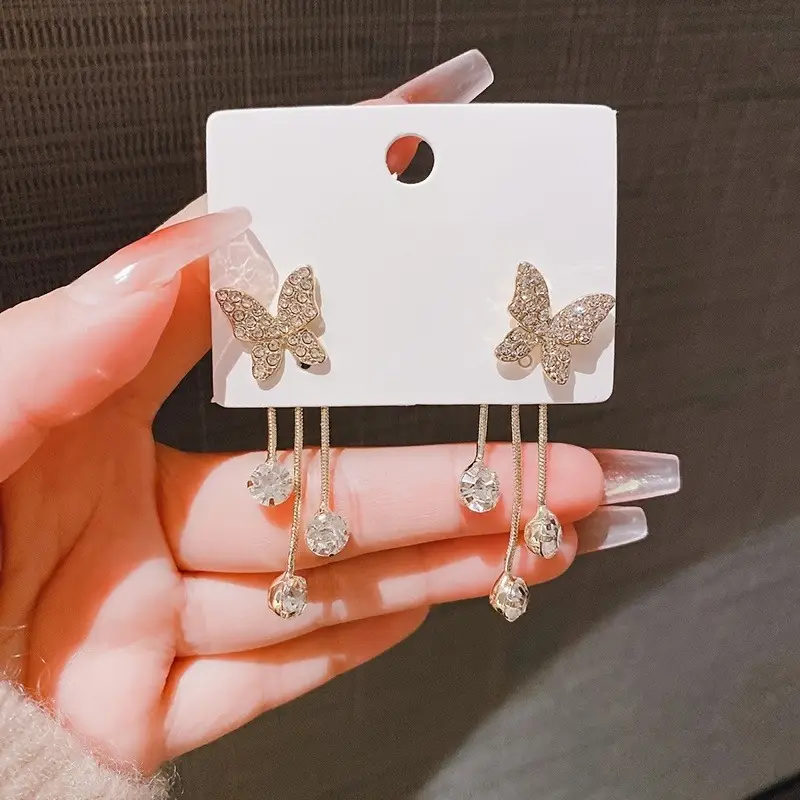 Elegant gold butterfly dangle earrings with sparkling zirconia accents, stylish jewelry for weddings and everyday glamour
