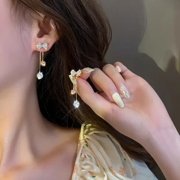 Elegant gold butterfly dangle earrings with sparkling zirconia accents, stylish jewelry for weddings and everyday glamour