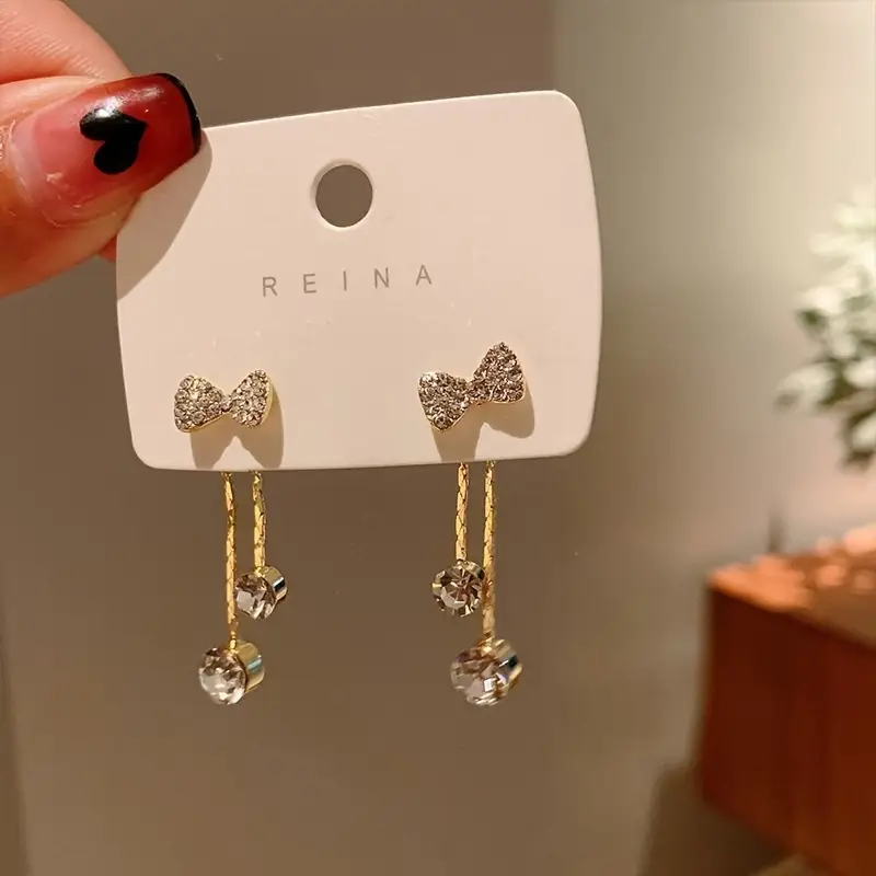 Elegant gold butterfly dangle earrings with sparkling zirconia accents, stylish jewelry for weddings and everyday glamour