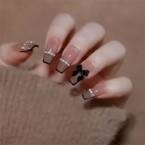 24pcs luxury press-on nails set with mixed colors, medium-length ballet shape, glossy finish, glitter accents, houndstooth patterns, black bow, and 3D diamond chain design