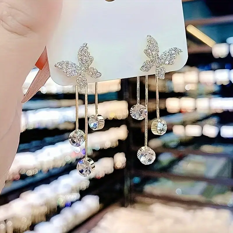 Elegant gold butterfly dangle earrings with sparkling zirconia accents, stylish jewelry for weddings and everyday glamour