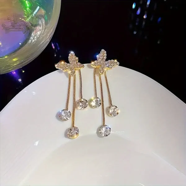Elegant gold butterfly dangle earrings with sparkling zirconia accents, stylish jewelry for weddings and everyday glamour