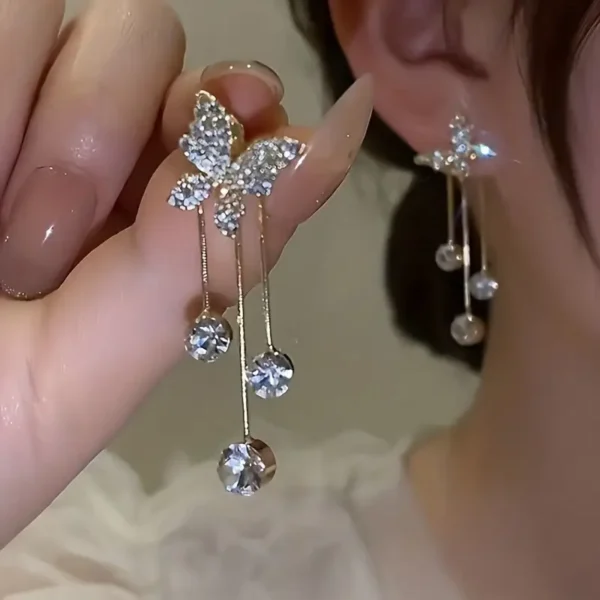 Elegant gold butterfly dangle earrings with sparkling zirconia accents, stylish jewelry for weddings and everyday glamour