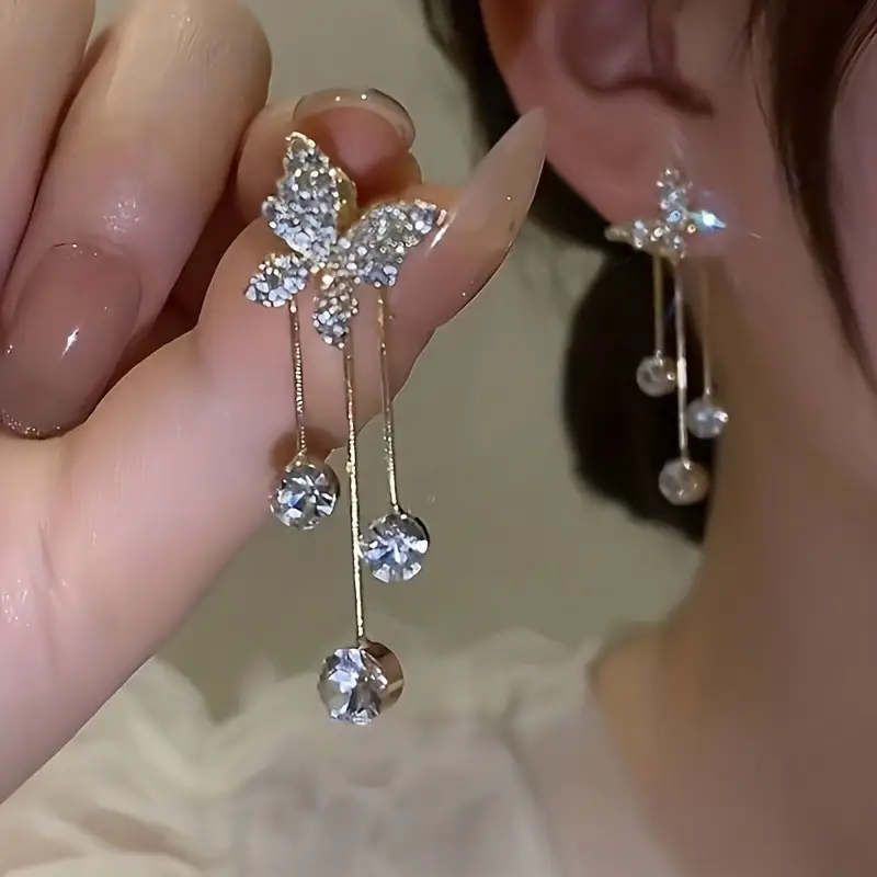 Elegant gold butterfly dangle earrings with sparkling zirconia accents, stylish jewelry for weddings and everyday glamour